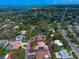 Beautiful home with a red tile roof situated in a neighborhood near a road and in the distance a body of water at 307 Palmetto Ln, Largo, FL 33770