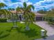 Aerial view of the home showcasing the paver driveway, lush lawn, and well-maintained landscaping at 307 Palmetto Ln, Largo, FL 33770
