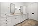 Bathroom features double sinks, marble countertops, and white cabinetry at 307 Palmetto Ln, Largo, FL 33770