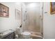 Bathroom boasts elegant tile shower, frameless door and neutral decor at 307 Palmetto Ln, Largo, FL 33770