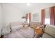 Bright Bedroom boasts soft carpet, neutral decor, and ample natural light at 307 Palmetto Ln, Largo, FL 33770