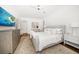 Bedroom with beige accents, light-colored walls, ceiling fan, and a neutral-patterned rug at 307 Palmetto Ln, Largo, FL 33770