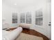 Corner of the bedroom with bright windows and hardwood floors at 307 Palmetto Ln, Largo, FL 33770