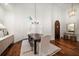 Elegant dining area with a modern chandelier, shuttered windows, and stylish furnishings at 307 Palmetto Ln, Largo, FL 33770