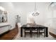 Spacious dining room featuring a dark wood table, white chairs and hardwood flooring at 307 Palmetto Ln, Largo, FL 33770