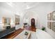 Grand entryway showcasing arched doorways, wood floors, built-in bar, and stylish decor at 307 Palmetto Ln, Largo, FL 33770