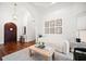 Inviting entryway with a wooden front door, art-lined walls, and a cozy seating area at 307 Palmetto Ln, Largo, FL 33770