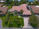 Stunning single-Gathering home featuring a red tile roof, lush landscaping, and a paver driveway leading to a two-car garage at 307 Palmetto Ln, Largo, FL 33770