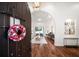Inviting foyer with hardwood floors, a decorative wreath, and a view into the bright living space at 307 Palmetto Ln, Largo, FL 33770