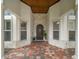 Charming front entrance with stone accents, a wooden door, and a colorful brick walkway at 307 Palmetto Ln, Largo, FL 33770