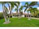 Stately home with a well-manicured lawn, paver driveway, and a two-car garage at 307 Palmetto Ln, Largo, FL 33770