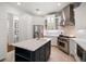 Modern kitchen with an island, stainless steel appliances, custom cabinets, and marble countertops at 307 Palmetto Ln, Largo, FL 33770