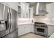 Gourmet kitchen featuring stainless steel appliances, custom cabinetry, and granite countertops at 307 Palmetto Ln, Largo, FL 33770