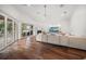 Bright living room with a fireplace, hardwood floors, and sliding glass doors to the outside at 307 Palmetto Ln, Largo, FL 33770