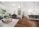Open living space featuring hardwood floors, built-in bar, dining area, and modern furnishings at 307 Palmetto Ln, Largo, FL 33770