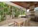 Patio dining area features a built-in kitchen and backyard landscaping at 307 Palmetto Ln, Largo, FL 33770