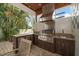 Covered outdoor kitchen with stainless steel appliances and a modern design at 307 Palmetto Ln, Largo, FL 33770