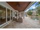 Inviting patio features outdoor seating, a pool with a tiki hut, and lush tropical landscaping at 307 Palmetto Ln, Largo, FL 33770