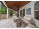 Outdoor patio area with comfortable seating, and views of the custom kitchen and landscaping at 307 Palmetto Ln, Largo, FL 33770
