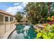 The backyard pool features tropical landscaping, a tiki bar, and a lush, private yard at 307 Palmetto Ln, Largo, FL 33770