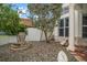 Landscaped side yard with a stone fountain, mature tree, and column architectural detail at 307 Palmetto Ln, Largo, FL 33770
