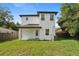 An eye-level shot showcases the home's backyard featuring a modern two-story design at 3105 E Osborne Ave, Tampa, FL 33610