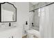 Well-lit bathroom featuring a marble countertop sink and marble-tiled shower and bathtub at 3105 E Osborne Ave, Tampa, FL 33610