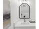 Modern bathroom featuring a black framed mirror, white countertop, and contemporary fixtures at 3105 E Osborne Ave, Tampa, FL 33610