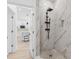 Beautiful walk-in shower with marble-look tile and black fixtures, conveniently located near the kitchen at 3105 E Osborne Ave, Tampa, FL 33610