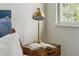 Cozy bedroom with a nightstand, a lamp, and an open book at 3105 E Osborne Ave, Tampa, FL 33610