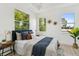 Inviting bedroom showcasing ample natural light, wood floors, and stylish decor at 3105 E Osborne Ave, Tampa, FL 33610