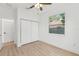Bright bedroom with a closet, a window, and wood-look flooring at 3105 E Osborne Ave, Tampa, FL 33610