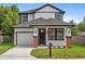 Charming two-story home with black trim, columns with brick bases, and a well-maintained lawn at 3105 E Osborne Ave, Tampa, FL 33610