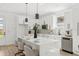 Beautiful kitchen featuring white cabinets, stainless steel appliances and an island with pendant lighting at 3105 E Osborne Ave, Tampa, FL 33610