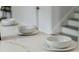 Close up view of white quartz countertops on a kitchen island with breakfast bowl set at 3105 E Osborne Ave, Tampa, FL 33610