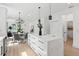 Bright kitchen with white island and stainless steel appliances next to dining area at 3105 E Osborne Ave, Tampa, FL 33610