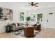 Bright living room with modern furniture, a ceiling fan, an entry door, and natural light through windows at 3105 E Osborne Ave, Tampa, FL 33610