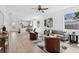 Bright, open-concept living room with stylish furniture, modern decor, and beautiful light wood floors at 3105 E Osborne Ave, Tampa, FL 33610