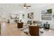 Bright, open-concept living room with stylish furniture, modern decor, and beautiful light wood floors at 3105 E Osborne Ave, Tampa, FL 33610