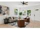 Bright living room with modern furniture, a ceiling fan, an entry door, and natural light through windows at 3105 E Osborne Ave, Tampa, FL 33610