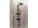 Close-up of the shower system showing black fixtures and marble style tiling at 3105 E Osborne Ave, Tampa, FL 33610