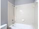 Close-up of the tiled bathtub and shower with updated fixtures at 3111 W De Leon St # 2, Tampa, FL 33609