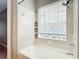 Bright bathroom featuring a tub with tile surround and window at 3111 W De Leon St # 2, Tampa, FL 33609