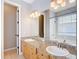 Bathroom with granite countertops, double sinks, and a large mirror at 3111 W De Leon St # 2, Tampa, FL 33609