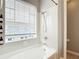 Bright bathroom featuring a tub with tile surround and window at 3111 W De Leon St # 2, Tampa, FL 33609