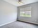 Cozy bedroom with neutral walls and carpet, bright window, and ceiling fan at 3111 W De Leon St # 2, Tampa, FL 33609