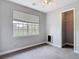 Bedroom with carpet, trim, closet, and bright window at 3111 W De Leon St # 2, Tampa, FL 33609