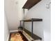 Under stair closet with custom wood shelving and supports at 3111 W De Leon St # 2, Tampa, FL 33609