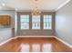 Bright dining room features hardwood floors, modern lighting fixture, and three large windows at 3111 W De Leon St # 2, Tampa, FL 33609