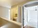 Hallway with laundry closet and doorway to a bedroom with ceiling fan at 3111 W De Leon St # 2, Tampa, FL 33609